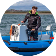 Image of a person driving a powerboat to depict a Powerboat Instructor Candidate